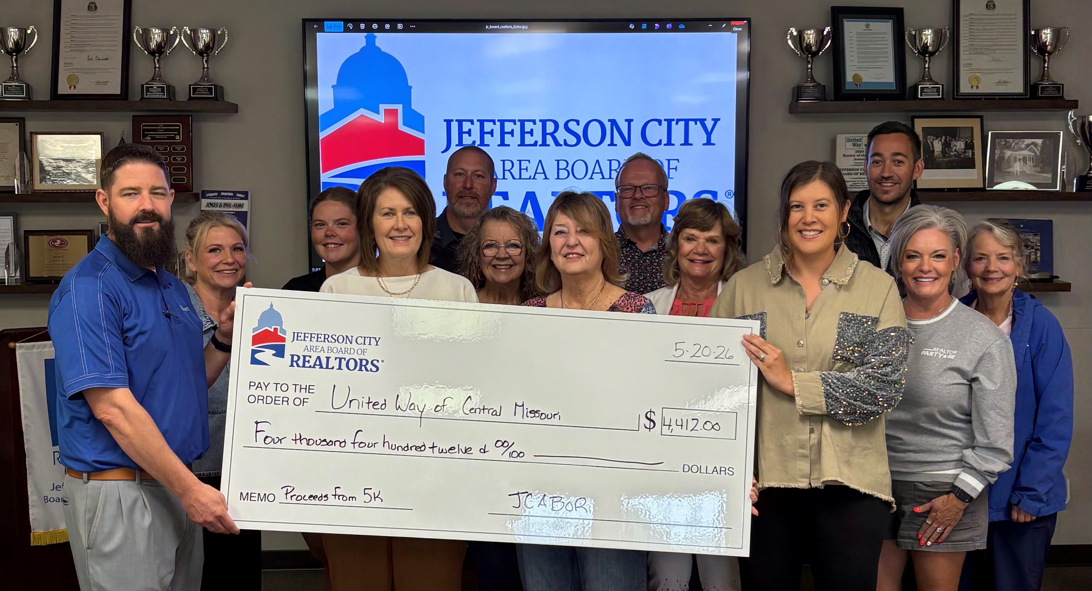 Check presentation to United Way; Proceeds from 5K Run/Walk